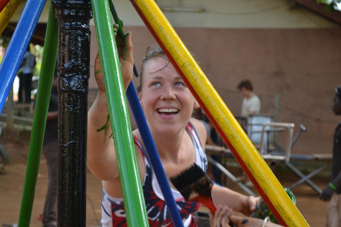 A Projects Abroad volunteer building in Ghana, helps paint a playground A volunteer paints a playground as part of her construction volunteering in Ghana